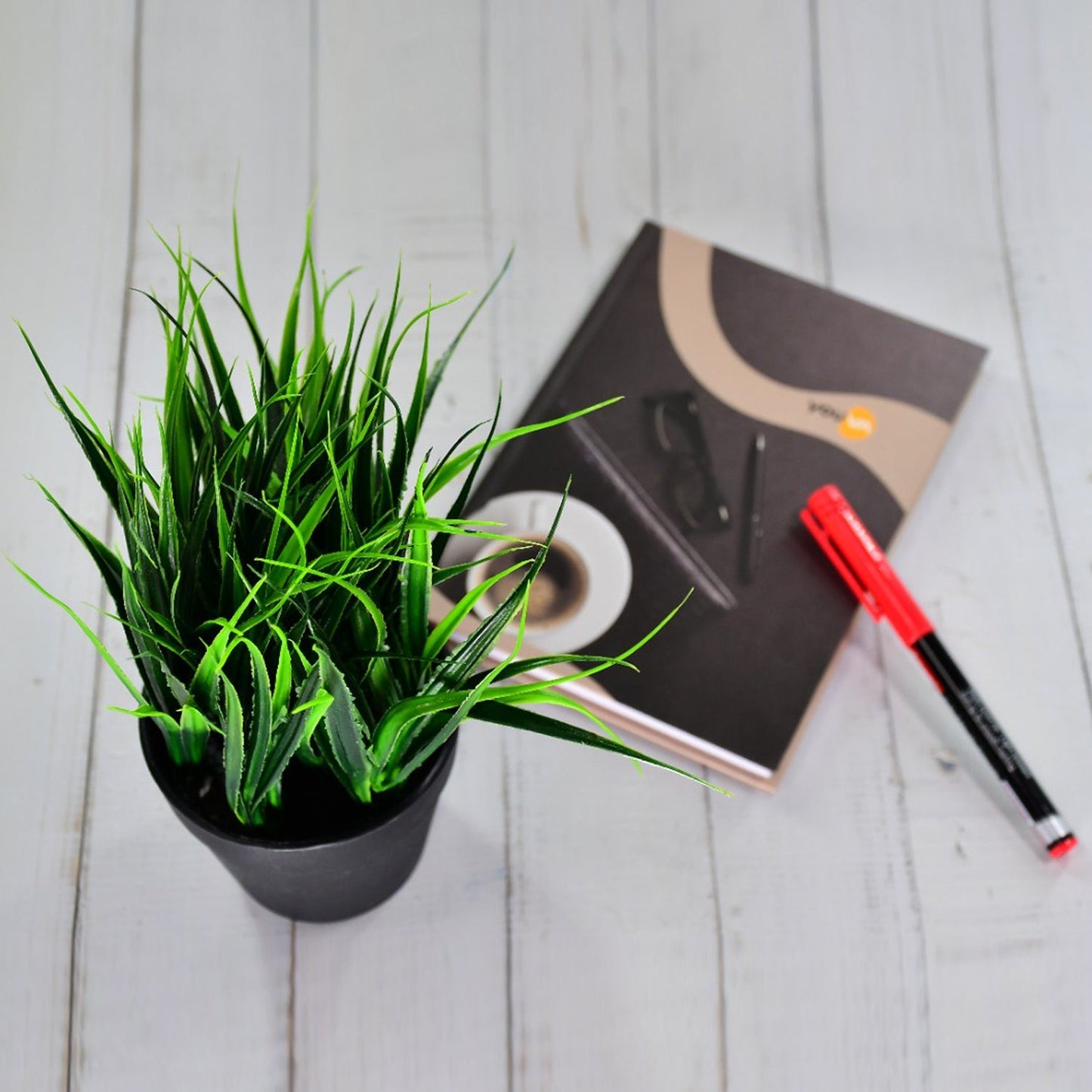 Artificial potted plant with a contemporary pot.