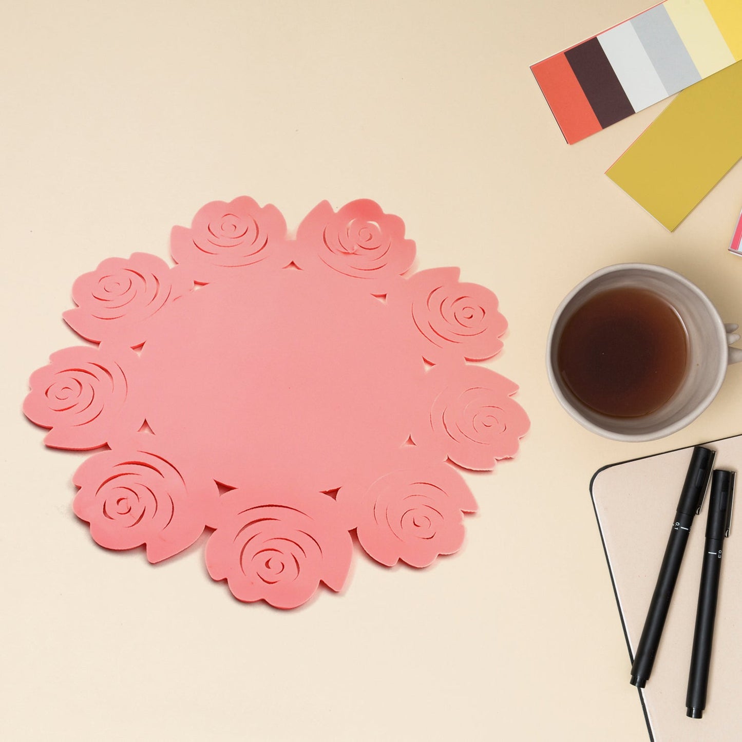 Rose-colored plate and cup mat with circular design