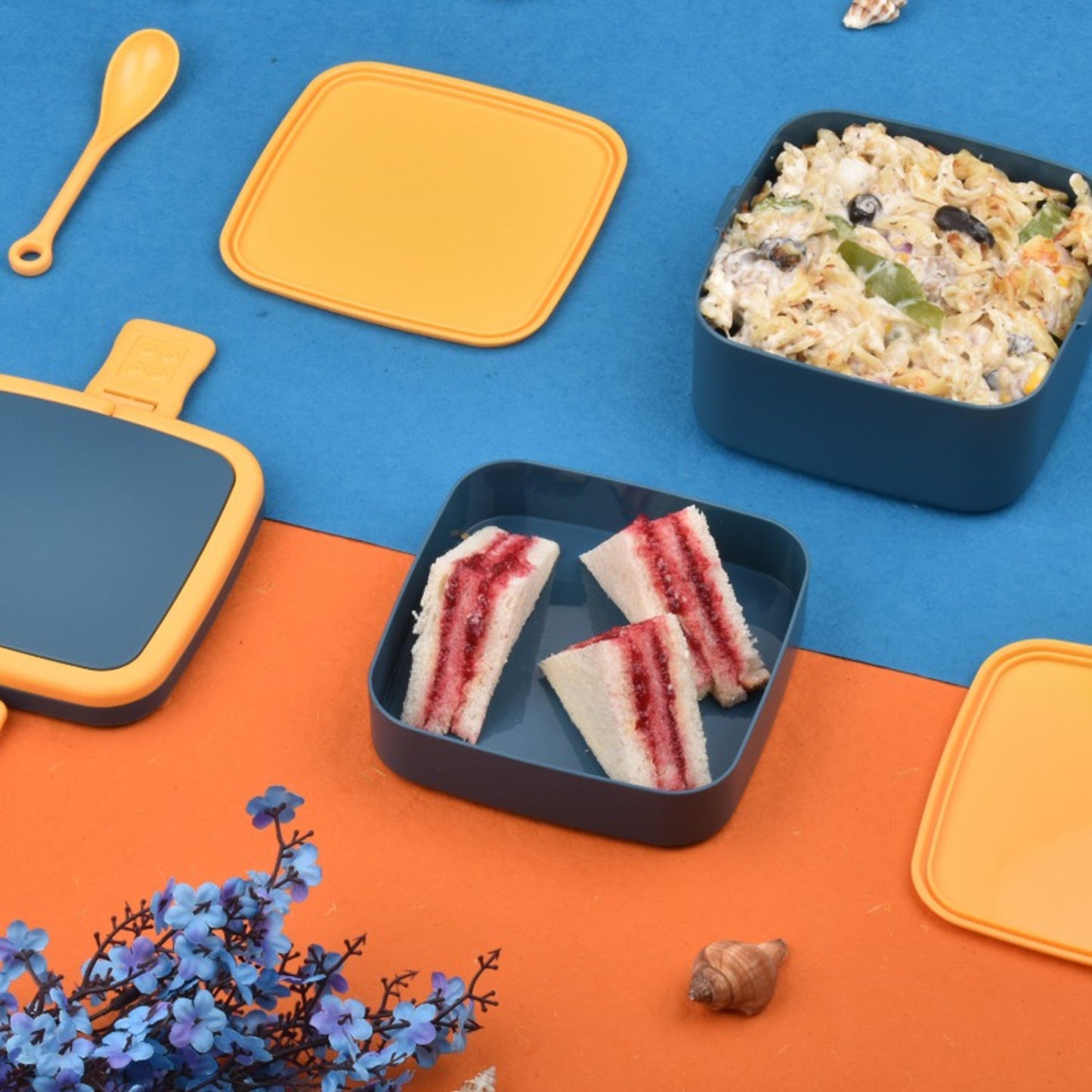 Blue lunch box with handle and spoon for meals