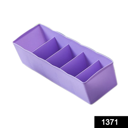 Clear plastic tray with dividers, used for storing beads and craft supplies.