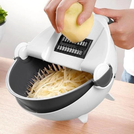 Multifunctional vegetable and fruit cutter with rotating drain basket in use