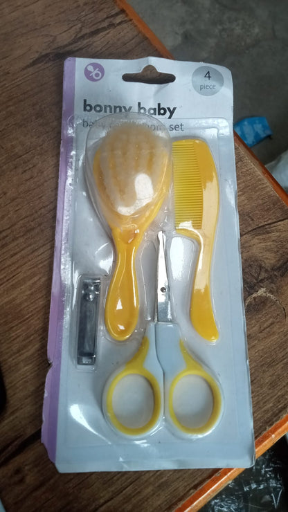 Essential baby health care kit with nail clipper, brush, comb, and scissors, ideal for grooming.